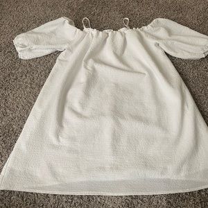 All white off the shoulder dress, with straps.